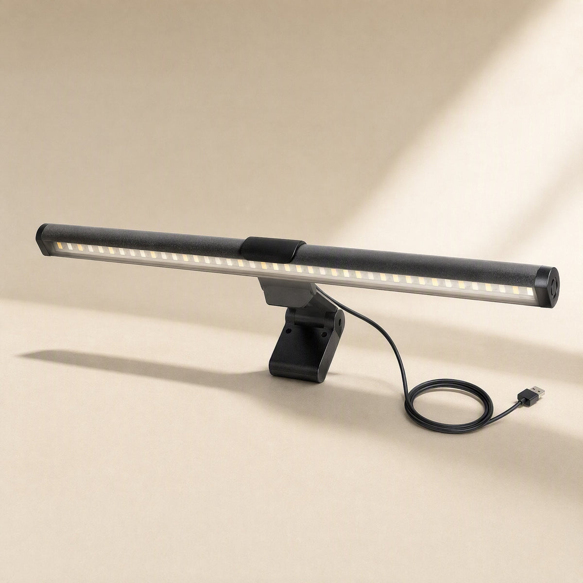 Metalgleam Metal Computer Screen Hanging Light – light bar glowing warm with a black USB cable coiled beside the clip base