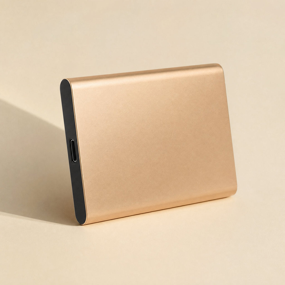 Steelsave – Gold-toned brushed metal portable drive angled upright, with the USB-C port on its dark end cap