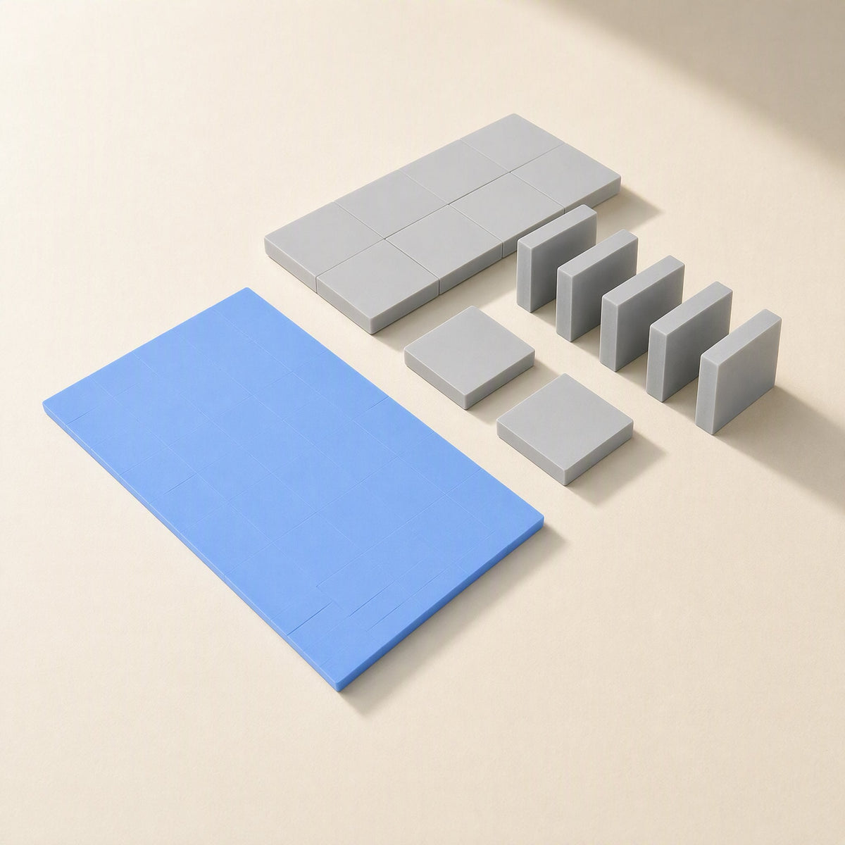Heatguard – Blue sheet beside gray silicone pads cut into small squares and rectangles, some standing on edge