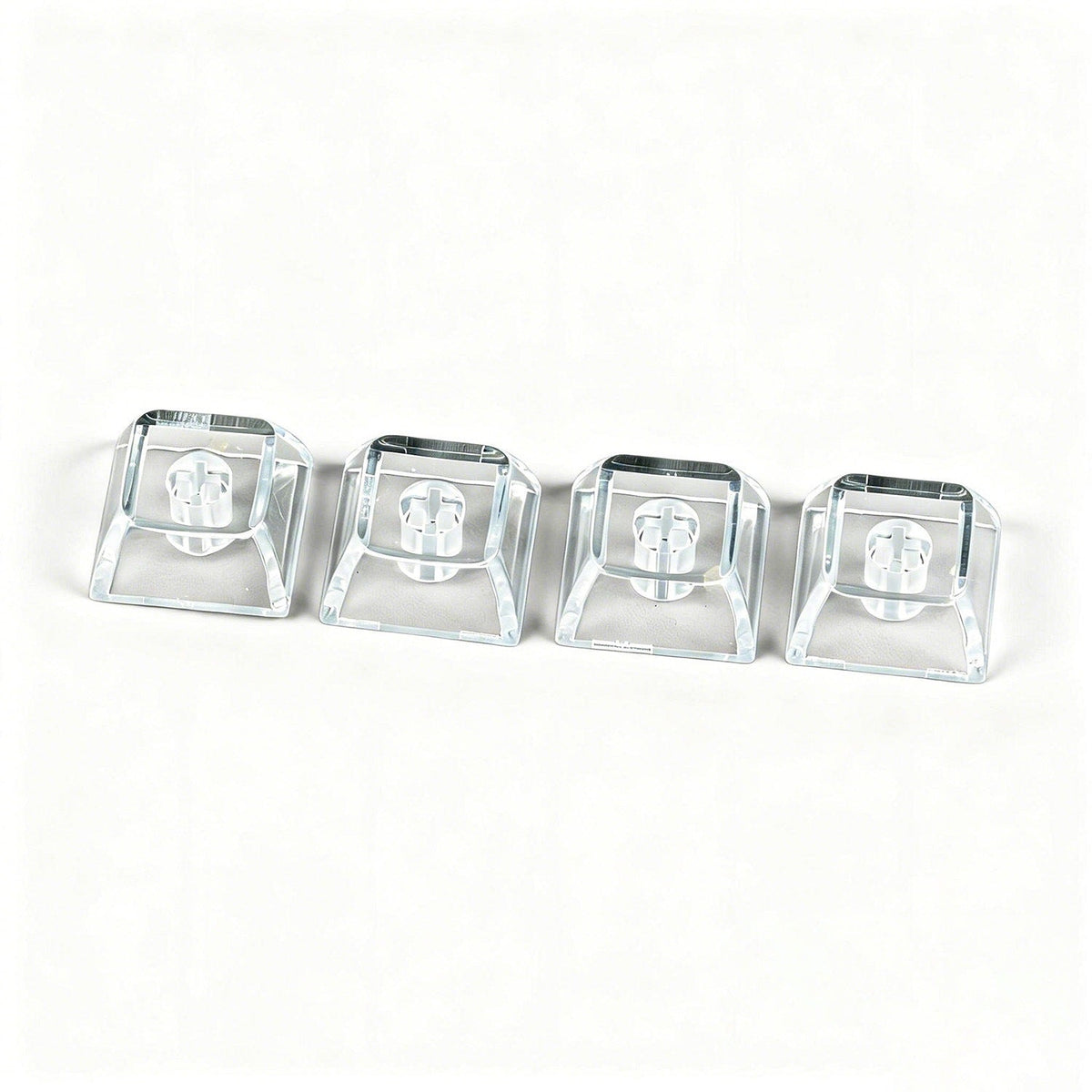 Clearcap – Four clear keycaps lined up in a row on a white background, shown from a slightly raised front angle