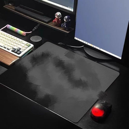 Padhold – Dark gray brush-pattern desk mat on a gaming desk with a keyboard, monitor and a mouse with red glowing light