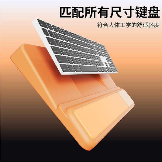 Softwrist – Orange silicone keyboard tray with wrist rest, shown tilted with a slim keyboard resting above it