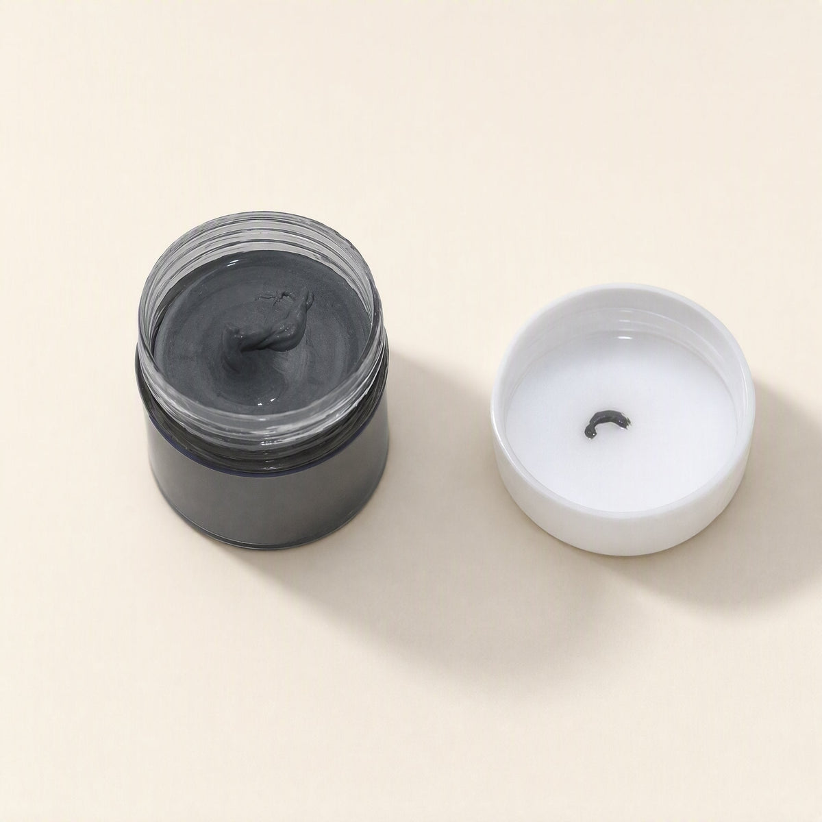 Thermabond 10g CPU Thermal Paste – open jar of gray silicone grease beside its white cap with a small smear of paste inside