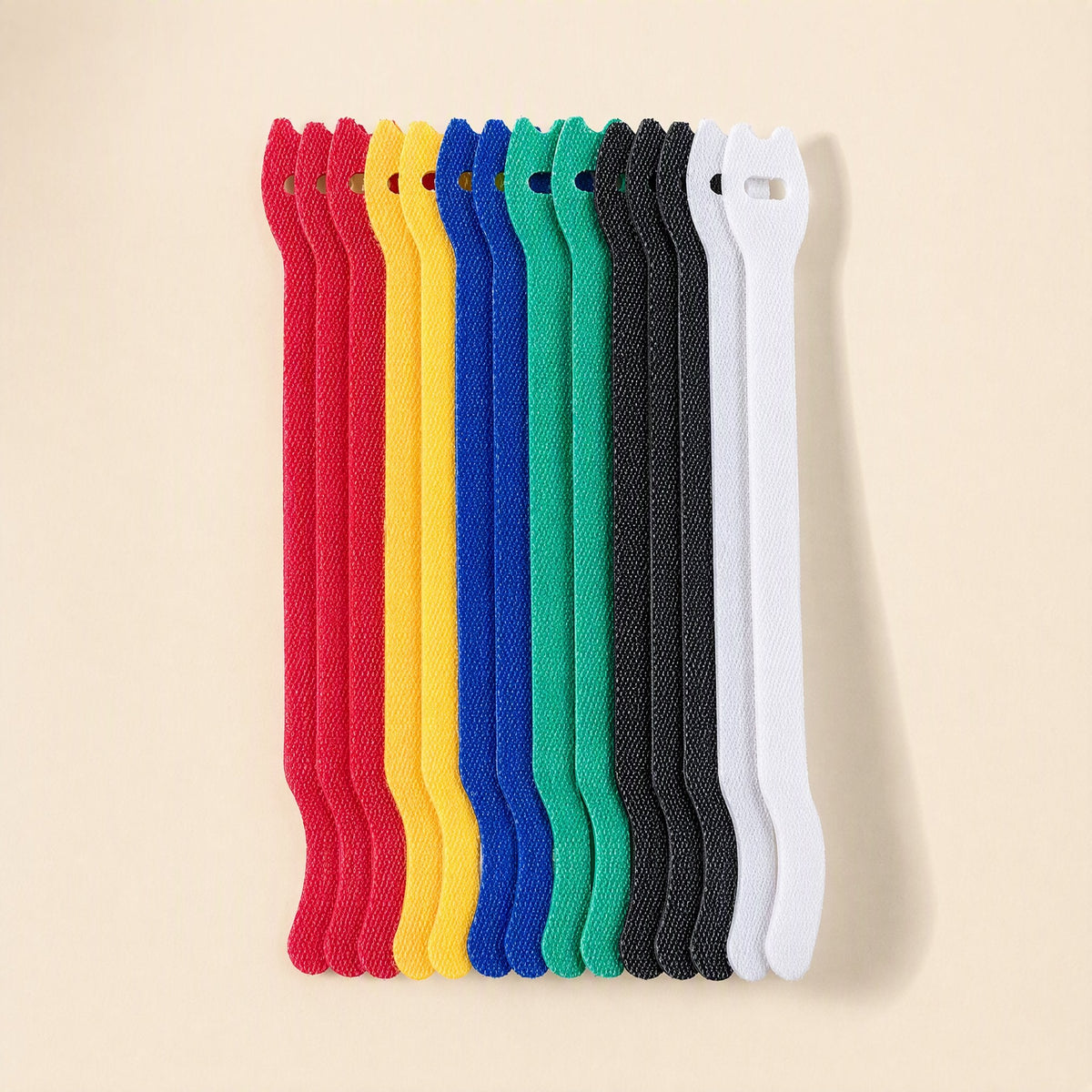 Loopstem – Row of upright hook-and-loop ties in red, yellow, blue, green, black and white standing side by side