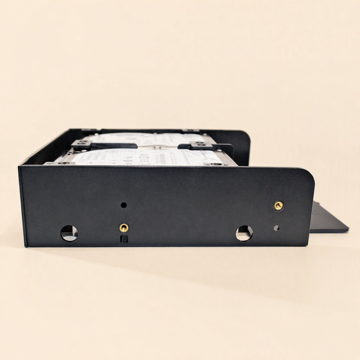 Baybridge – Side view of the black bracket showing round cutouts, threaded screw holes and two drives mounted inside