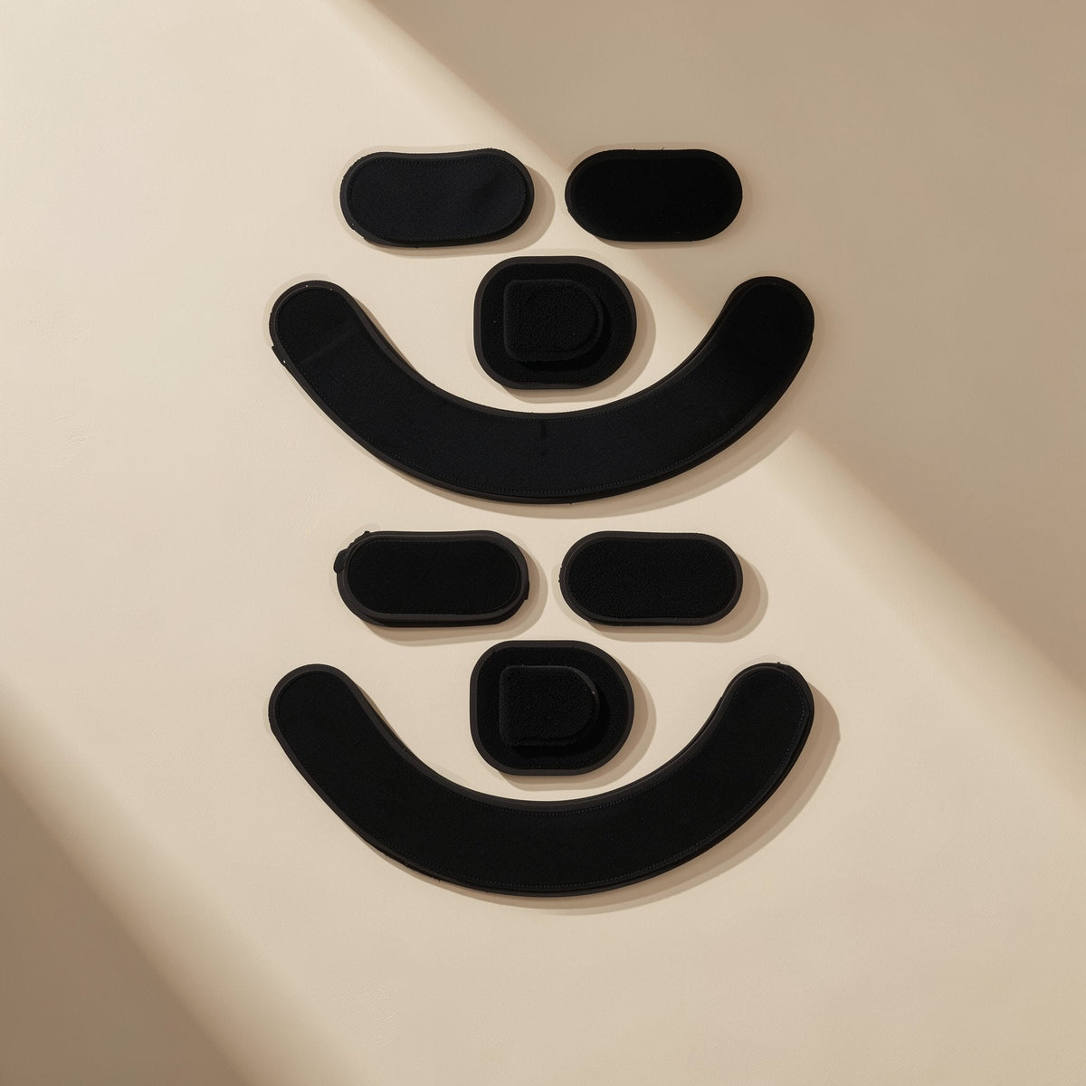 Glidefeet – Two sets of black mouse foot pads, each with two ovals, a squared piece and a wide curved strip