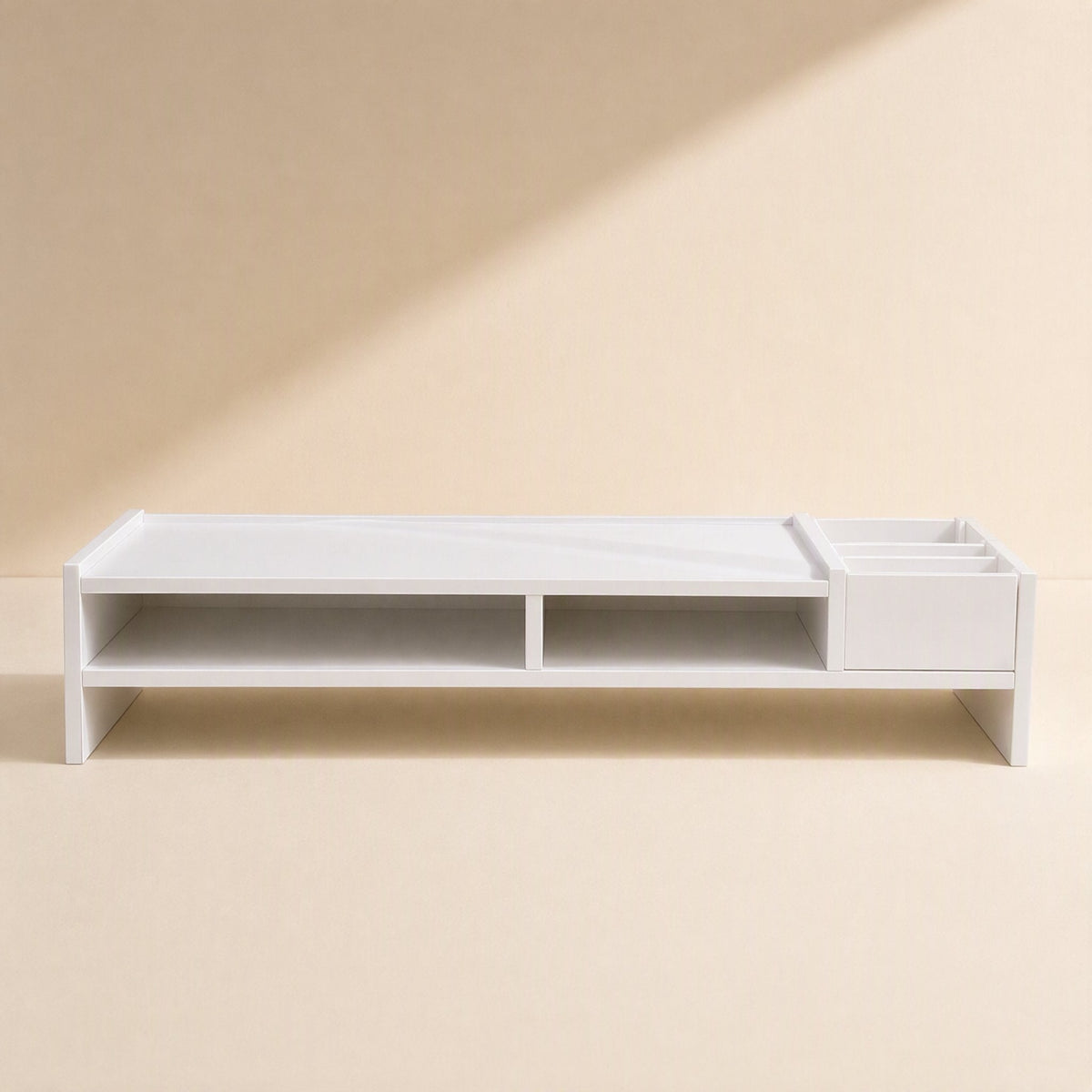 Screenstore – Long white desktop shelf viewed straight on, with two open cubbies and a three-section organiser on the right