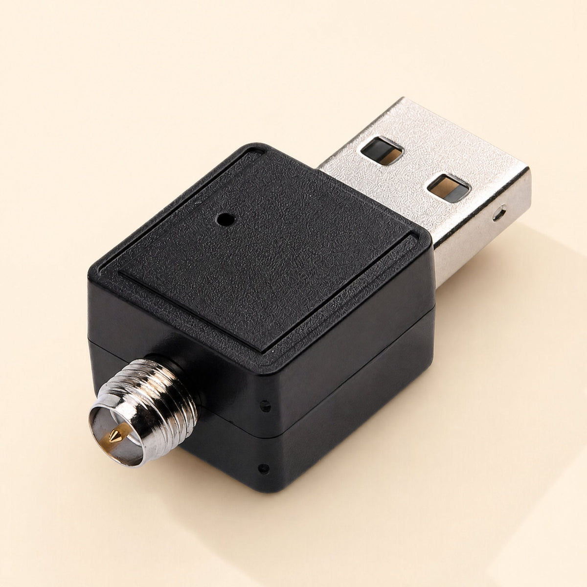 Netplug – Close-up of the adapter's square black body, silver USB plug and threaded antenna connector