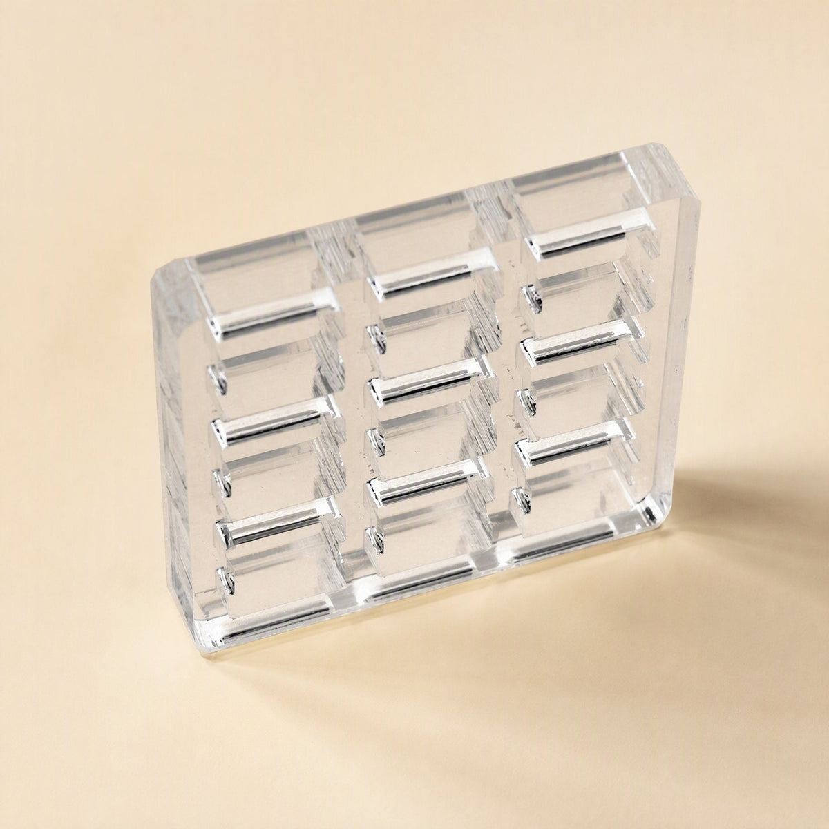 Switchframe – Compact three-column clear acrylic switch tester frame with rows of rectangular openings, angled view