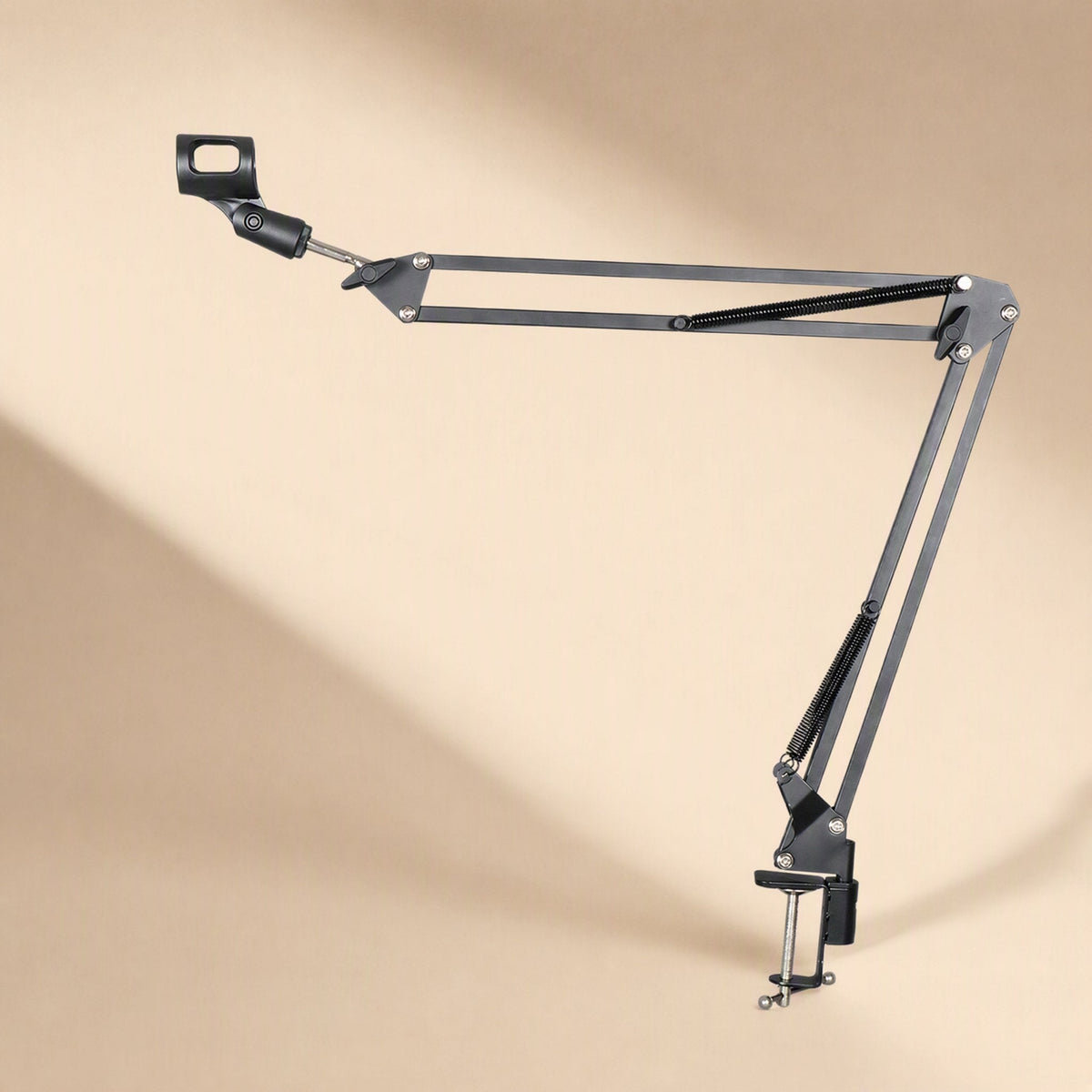 Deskarm – Metal cantilever mic arm with clamp, shown from the right on a warm beige background with soft shadow