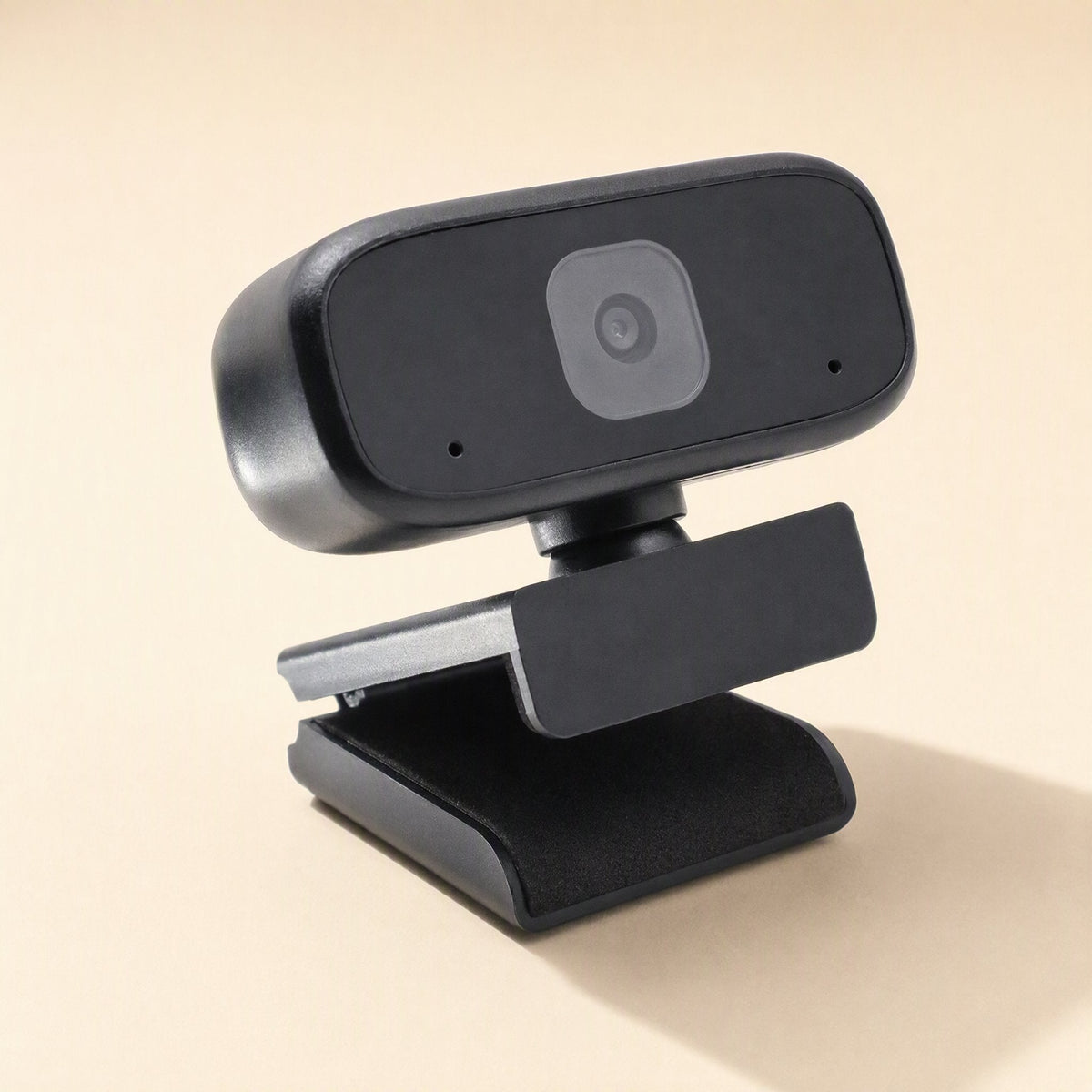 Voiceview – Rear-right angle of the black webcam showing its hinged clip and soft base pad