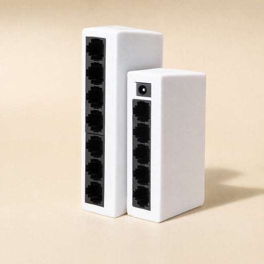 Gigaflow – Two white switches standing upright side by side, one with seven ports and one with five, power jack on top