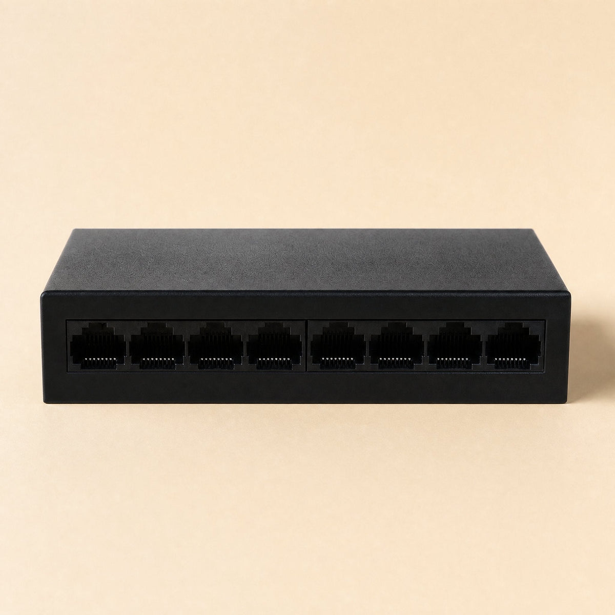 Gigaflow – Black eight-port switch from a slightly raised front angle, ports in two groups of four on beige