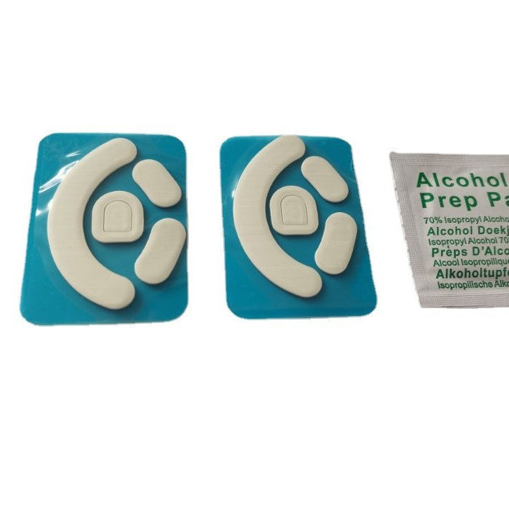 Skimfoot – Two white curved mouse foot sets on blue backing with an alcohol prep pad, on a plain white background