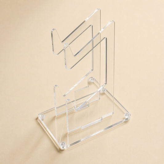Padstand – Top-down angled view of the empty clear acrylic stand with two tiers and corner screws on the base