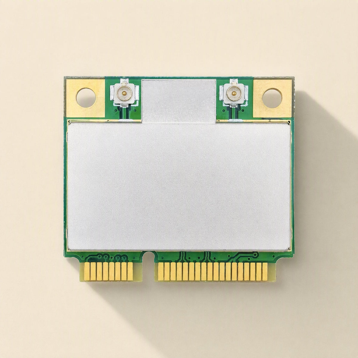 Linkchip – Front view of the green Mini PCIe card with blank silver shield, gold connector pins and two antenna ports