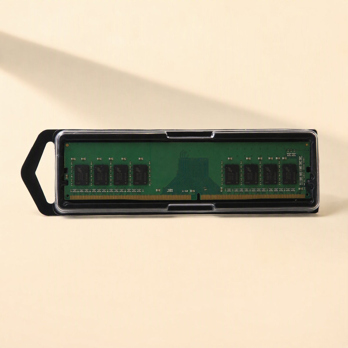 Byteboost – Single green memory module in a clear plastic case with a black pull tab, shown top-down