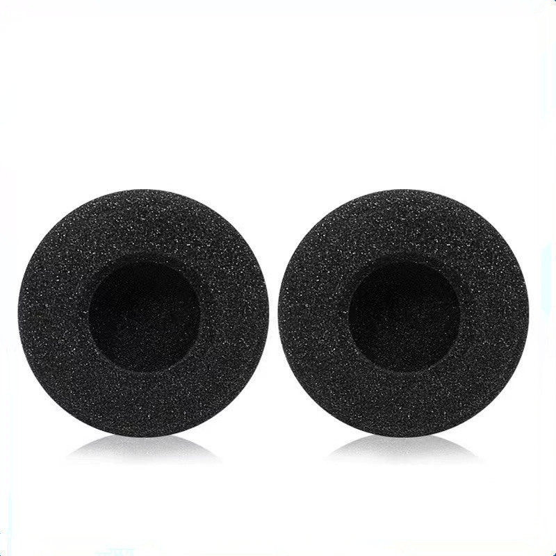 Earfoam – Pair of round black sponge ear cushions with recessed centers, shown side by side with soft reflections