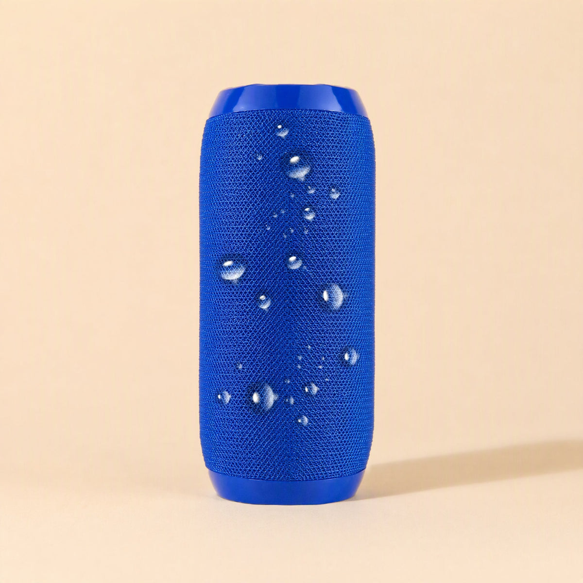 Pocketbeat – Solid blue speaker standing upright with water droplets beaded on the woven fabric surface