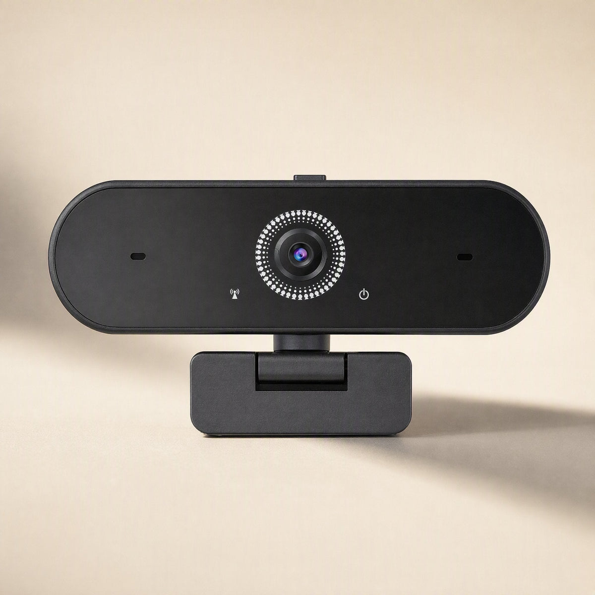 Talkframe – Front view of the black webcam on a short stand, with lens, microphone holes and power icon in focus