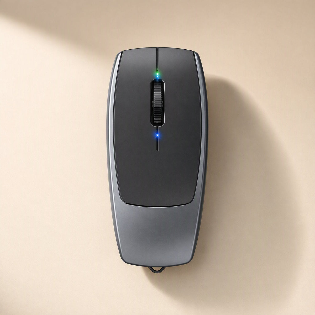 Clickmate – Top-down view of the grey and black mouse with lit green and blue LEDs and a small strap loop at the end