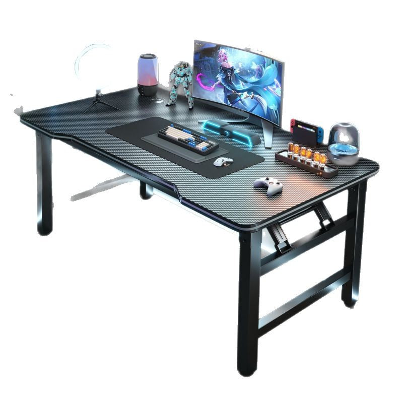Foldspan – Black folding desk with curved front edge, set with monitor, keyboard, mouse and game controller on a white