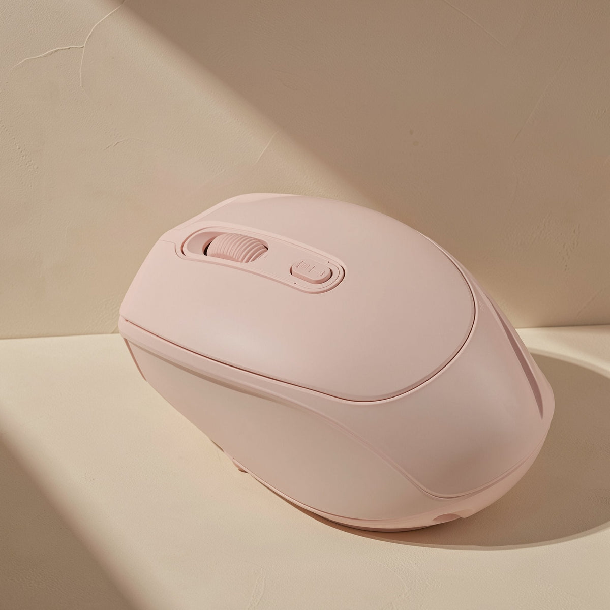 Modeglide – Pink mouse side view close up, showing the scroll wheel, mode button and curved right-hand grip