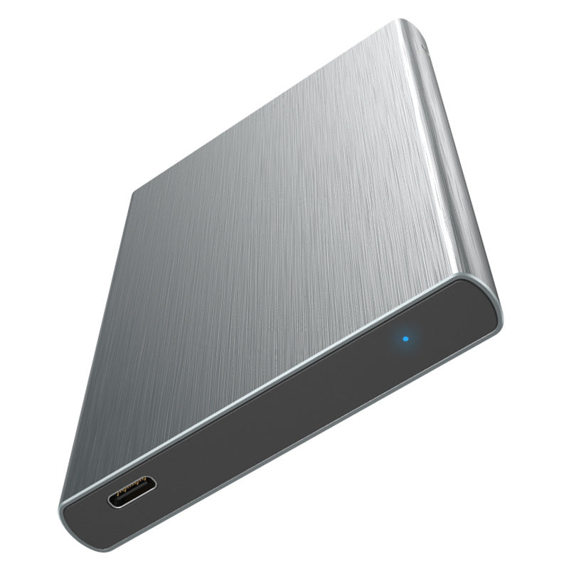 Alumacase – Gray brushed-aluminum drive enclosure at an angle, showing a USB-C port and a small blue indicator light