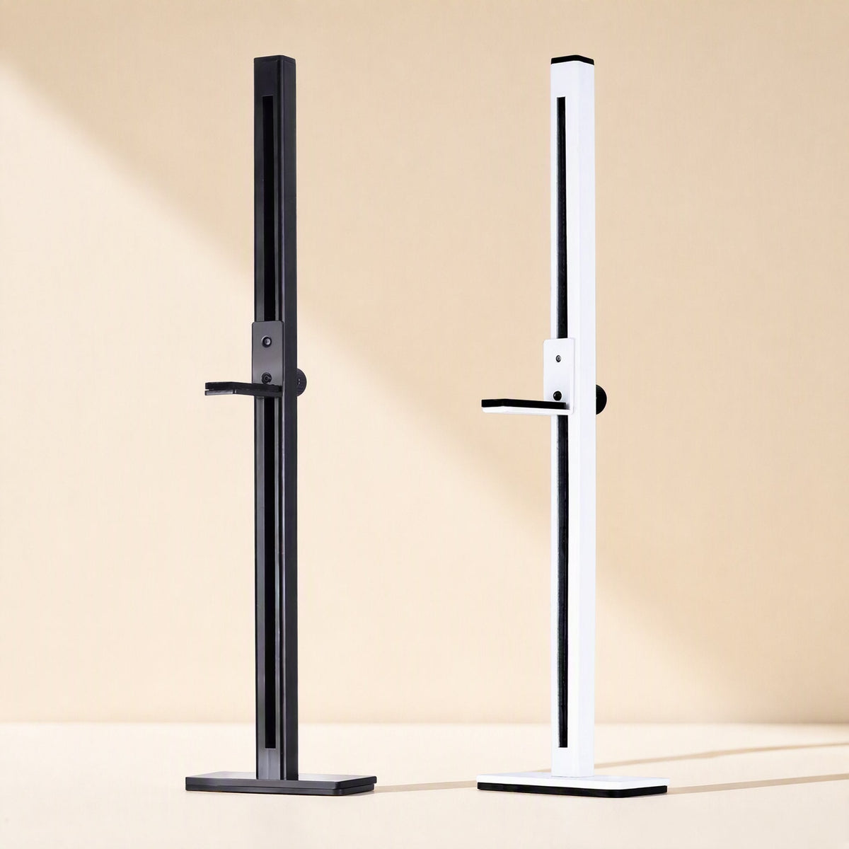 Chipstand – Black and white graphics card brackets side by side, each with a slotted post, sliding arm and flat base