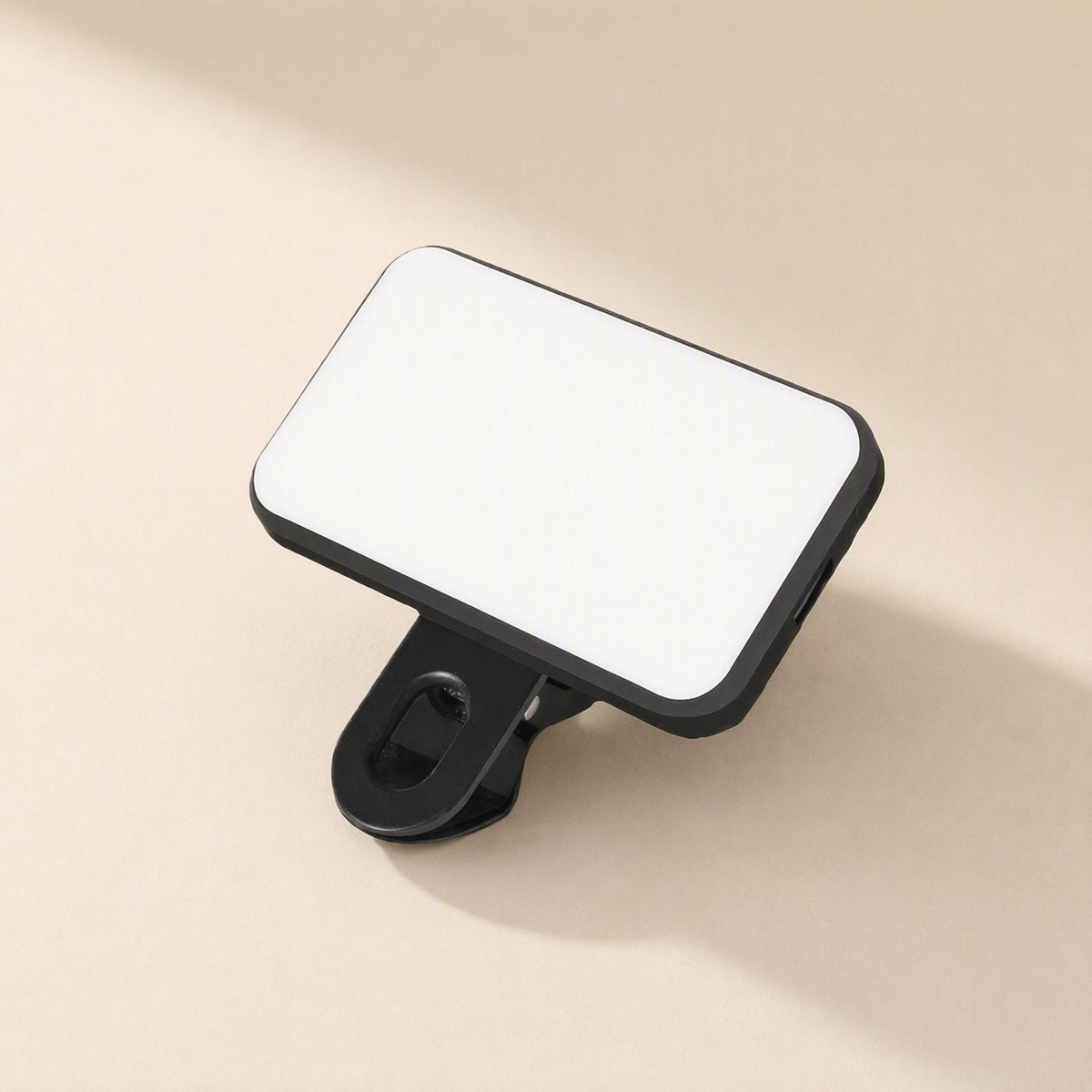 Snapshine – Black rectangular LED panel with rounded corners and a clip underneath, seen from above at a slant