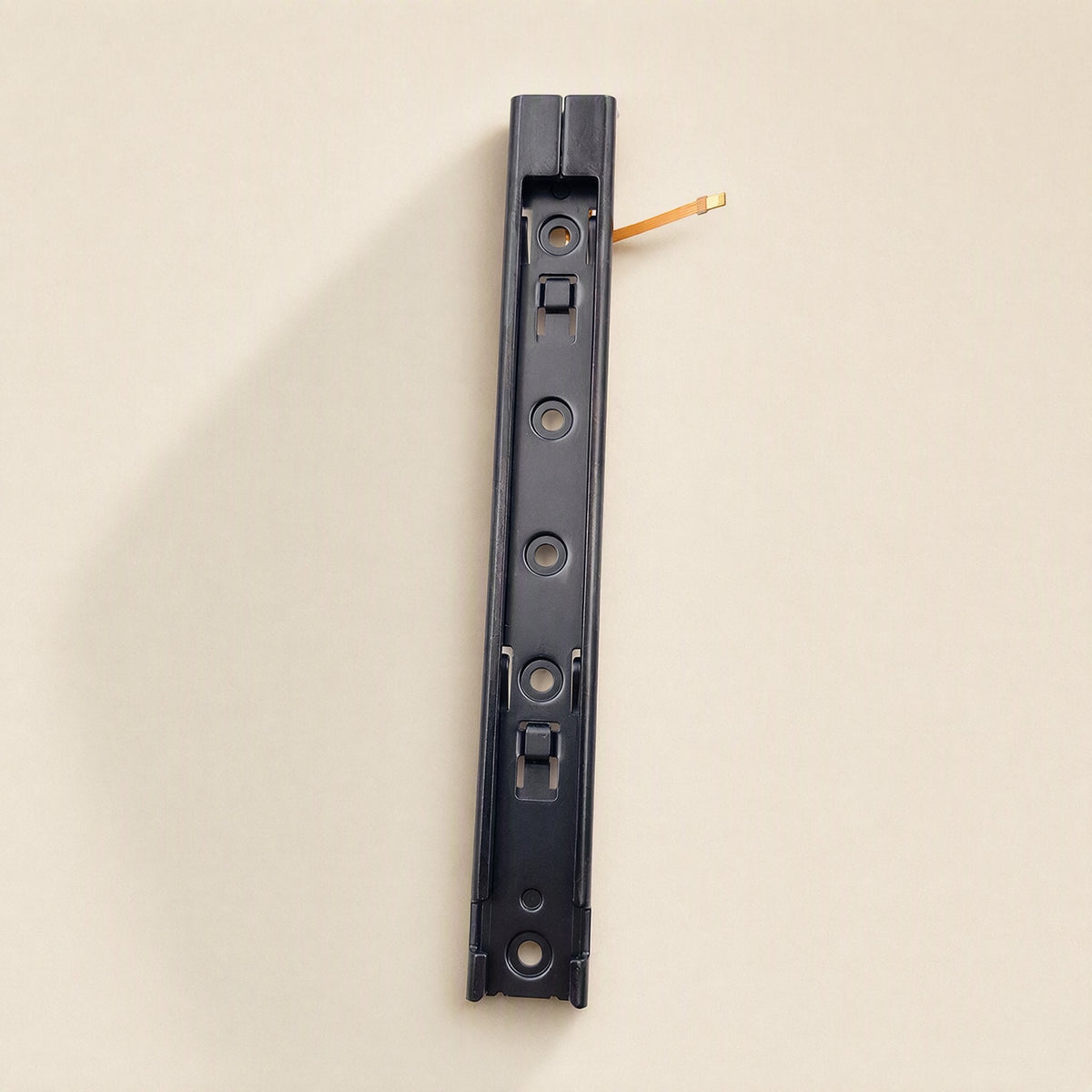 Railglide – Single slide rail seen from the bottom end with a short orange flex cable tip peeking out at the top