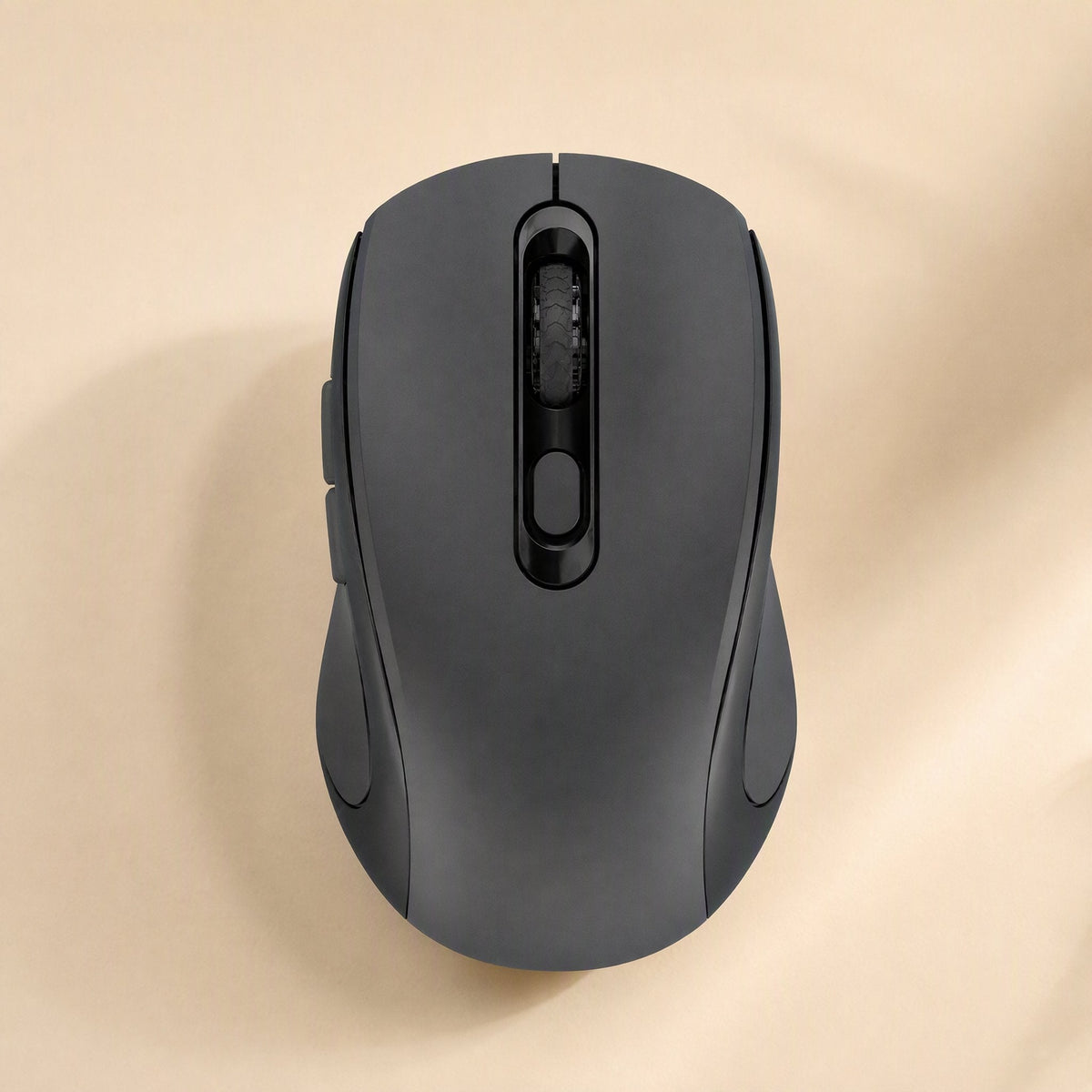 Voiceglide – Black wireless mouse top view with scroll wheel and center button on a warm beige surface