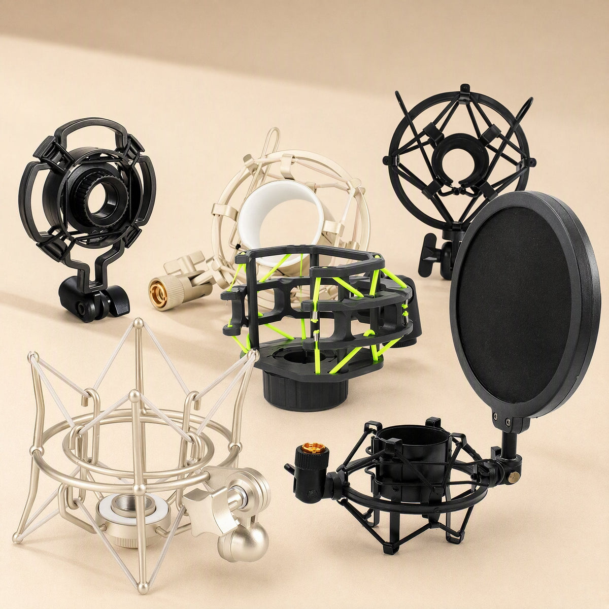 Micushion microphone shock mount group shot: black, champagne and cream mounts with a pop filter