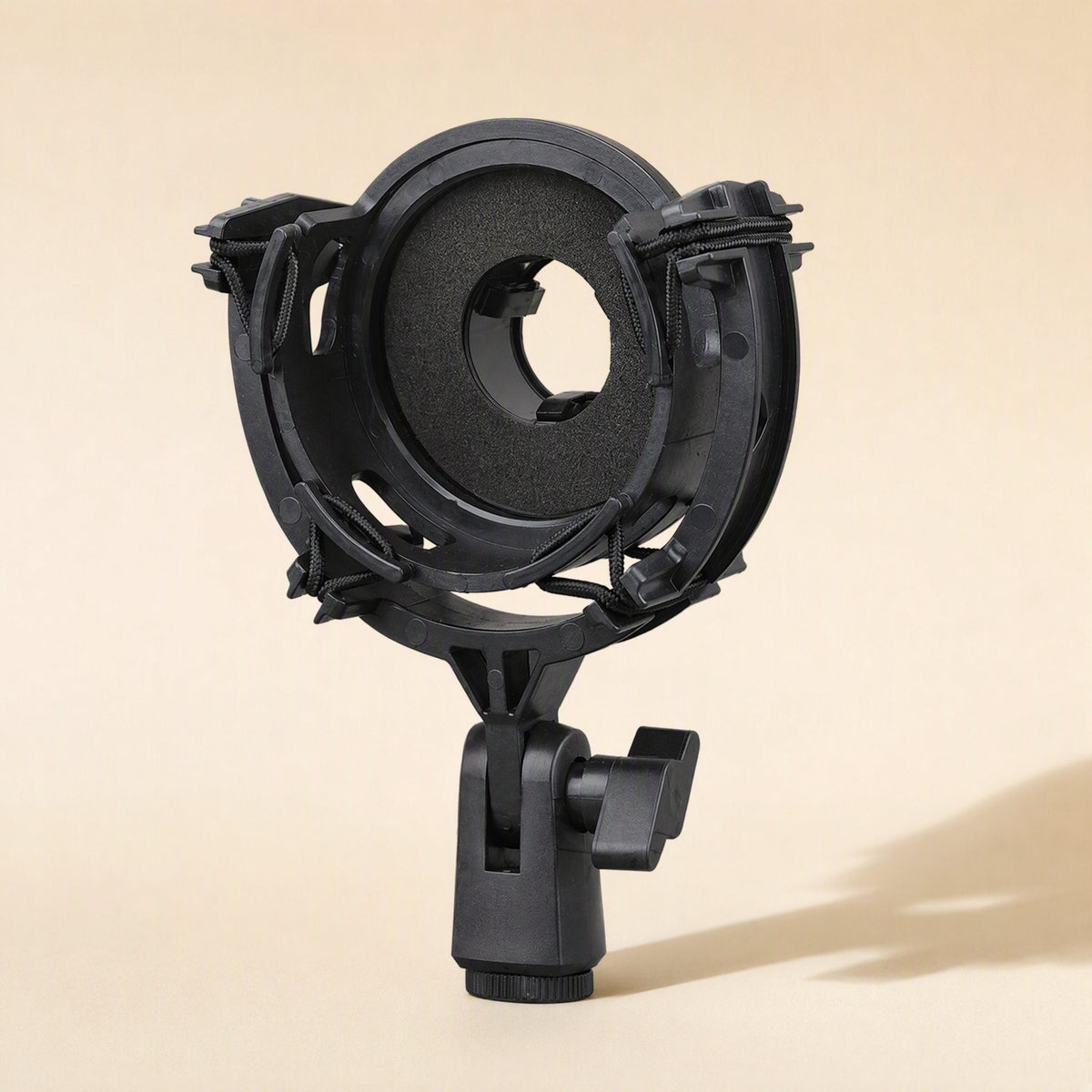Micushion – Black round shock mount with foam-padded ring and clamp stand, front view on beige background