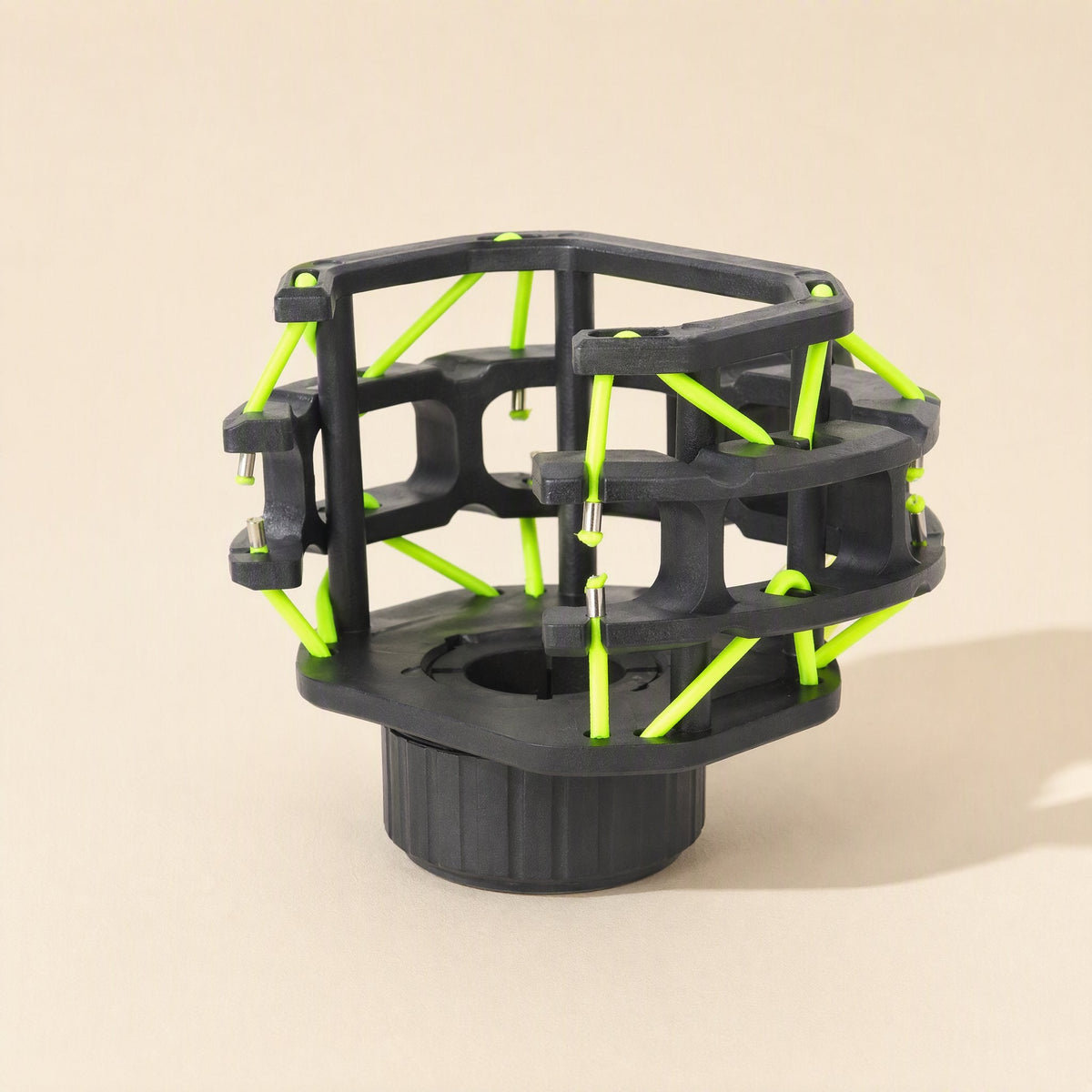 Micushion – Black shock mount frame with bright green elastic cords and a threaded round base, angled view