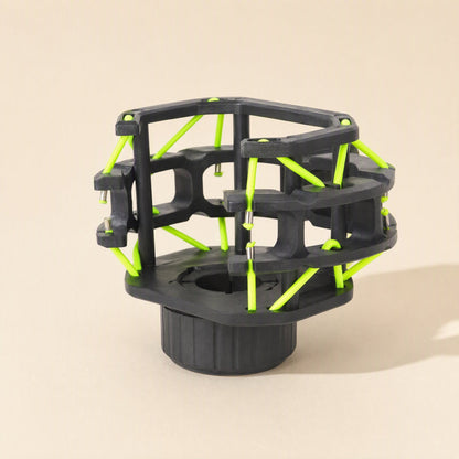 Micushion – Black shock mount frame with bright green elastic cords and a threaded round base, angled view
