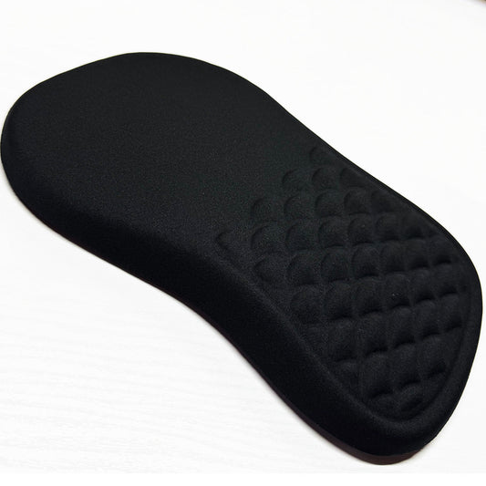 Gliderest – Black wrist rest pad with a textured, dimpled surface on one end, shown at an angle on a white surface