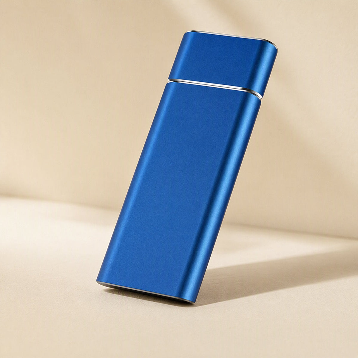 Driveforge – Blue slim aluminum portable drive standing at a slight angle against a beige background