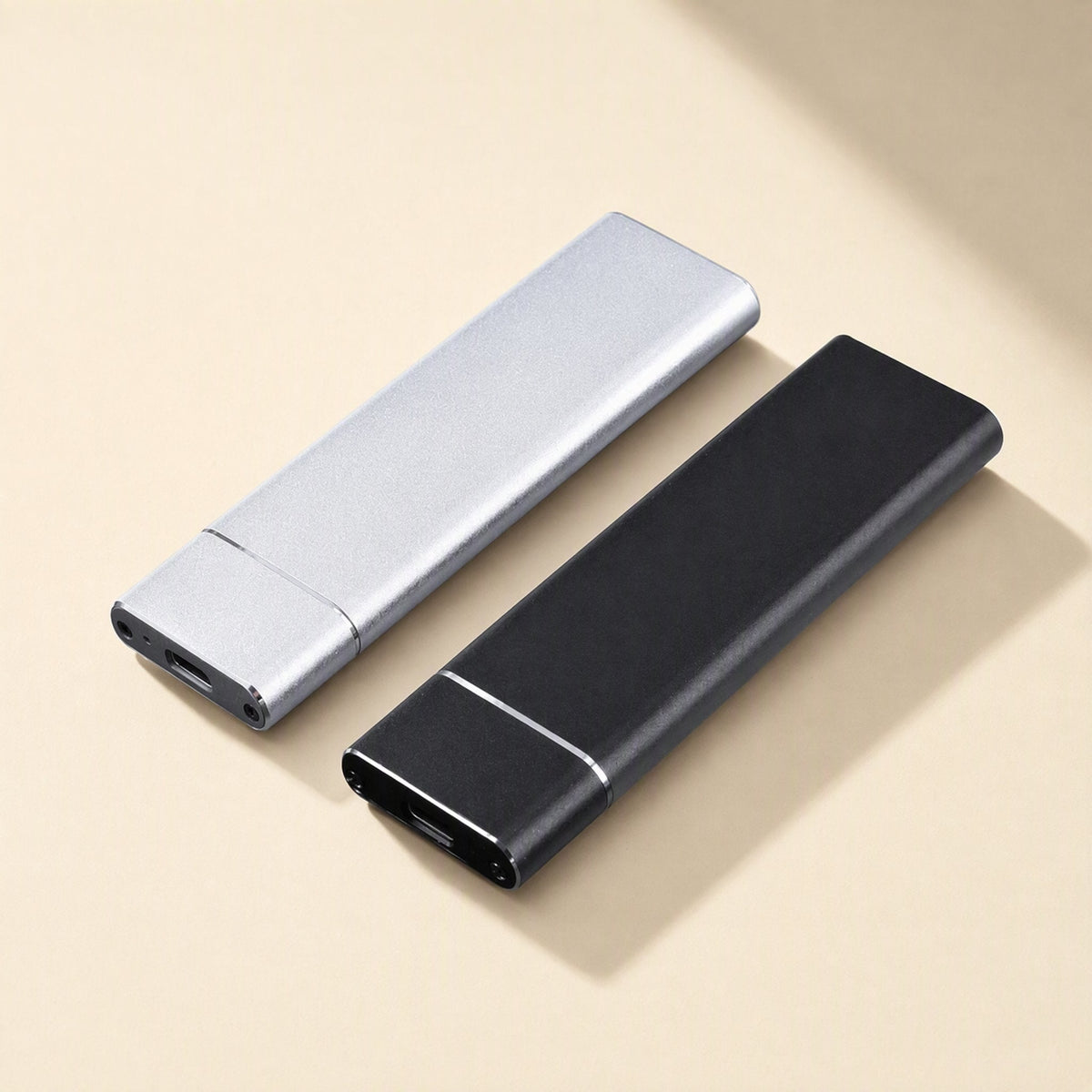 Driveforge – Silver and black slim drives lying side by side, USB-C ports visible at the front ends