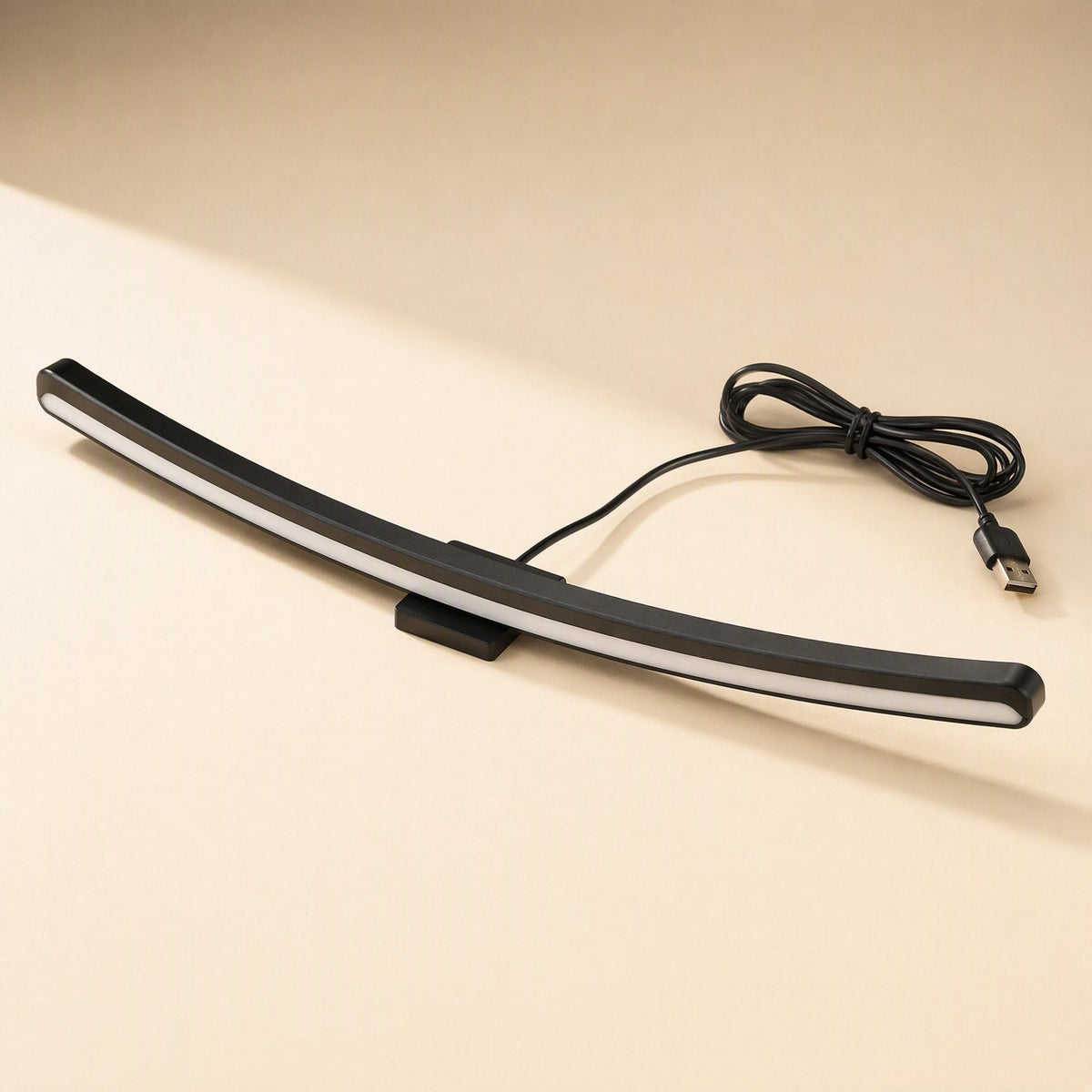 Taskbeam USB-Powered Monitor Screen Hanging Light, curved black bar with white glow and coiled USB cable