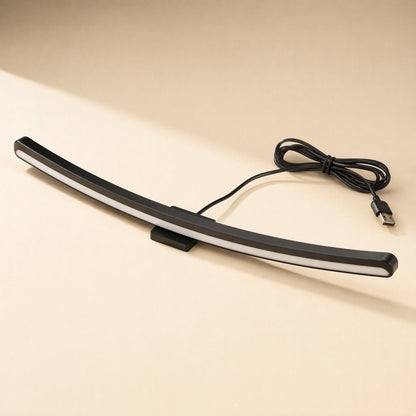 Taskbeam USB-Powered Monitor Screen Hanging Light, curved black bar with white glow and coiled USB cable
