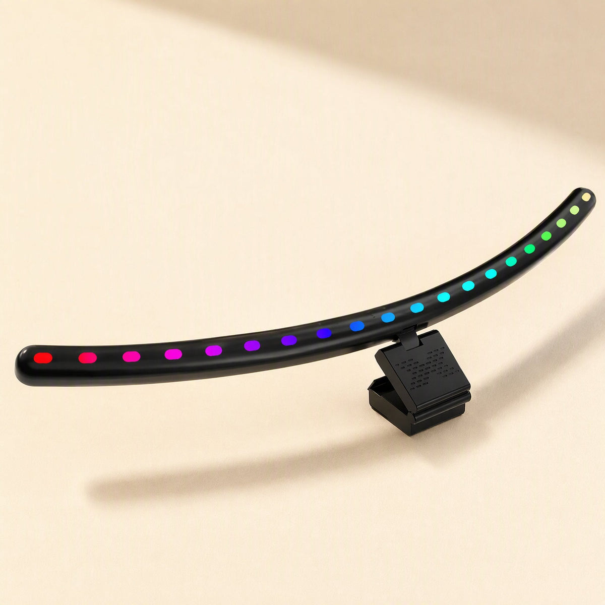 Taskbeam – Black light bar with red-to-green LED dots in a gradient, shown from the side with its monitor clip