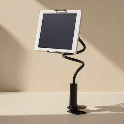 Rotaperch – White tablet held in a black gooseneck stand with a round base and desk clamp, against a beige wall
