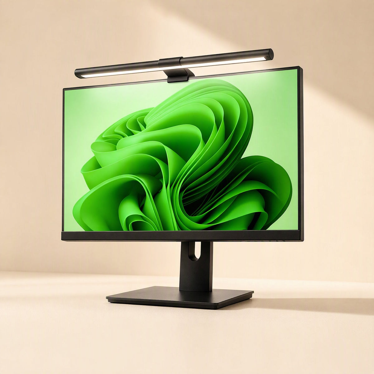 Screenlite Metal Monitor Hanging Light mounted on top of a monitor with a green wallpaper on a beige desk