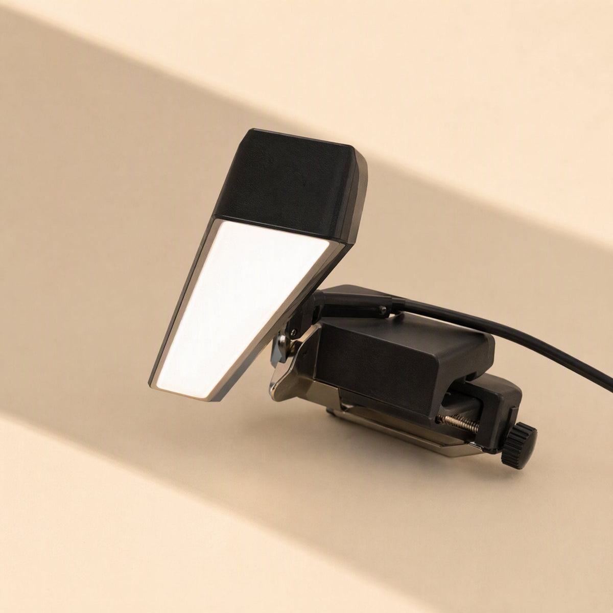 Screenlite Metal Monitor Hanging Light – close-up of the clamp and tilting lamp head with screw knob and black cable