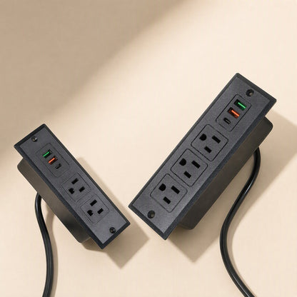 Deskcharge – Two black embedded sockets, 2-outlet and 3-outlet versions, each with USB ports and attached cord