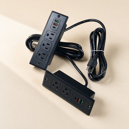 Deskcharge Embedded Desktop USB Power Socket – vertical and horizontal black sockets beside a coiled power cord with plug