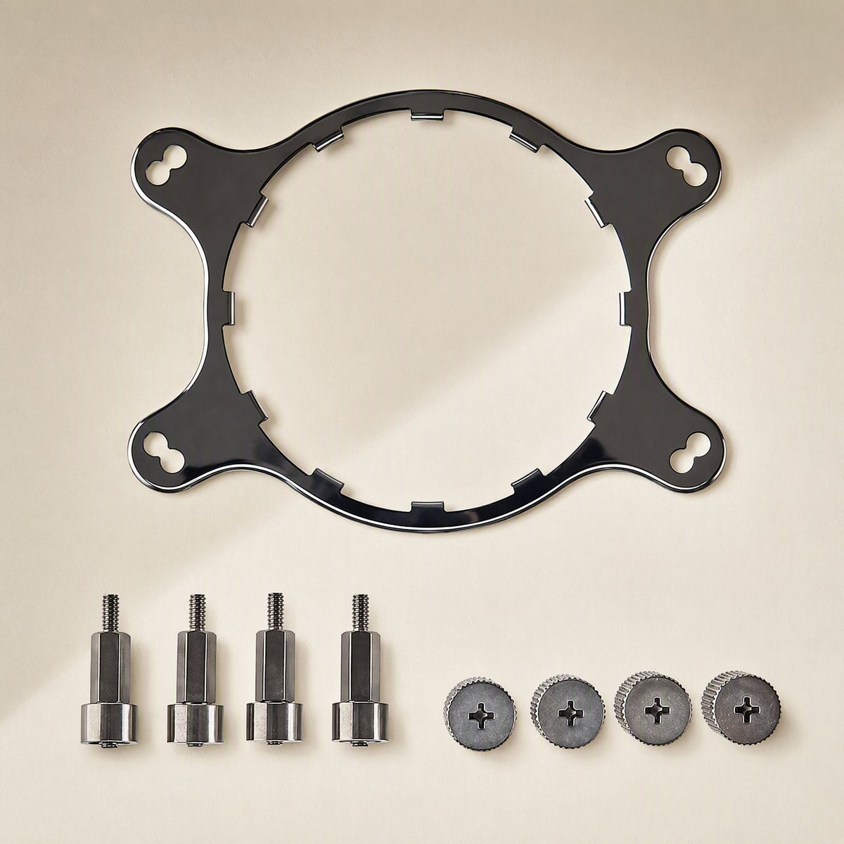 Coolmount – Flat lay of the steel ring bracket above four threaded standoffs and four knurled thumbscrews