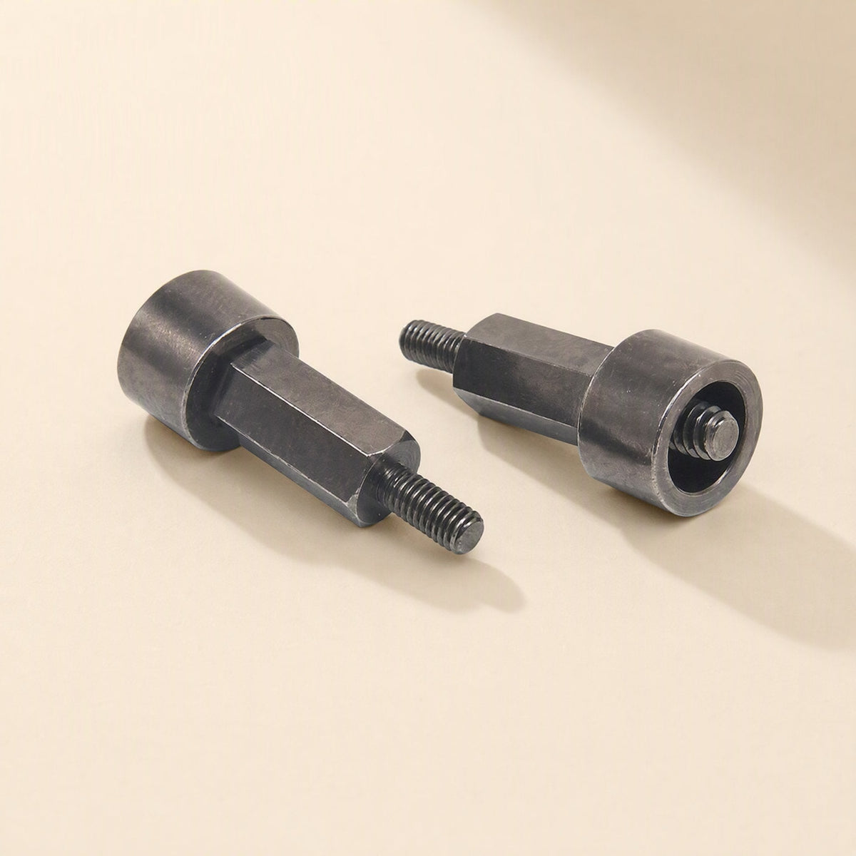 Coolmount – Close-up of two hex-body standoffs with threaded ends, one showing its hollow cylindrical base