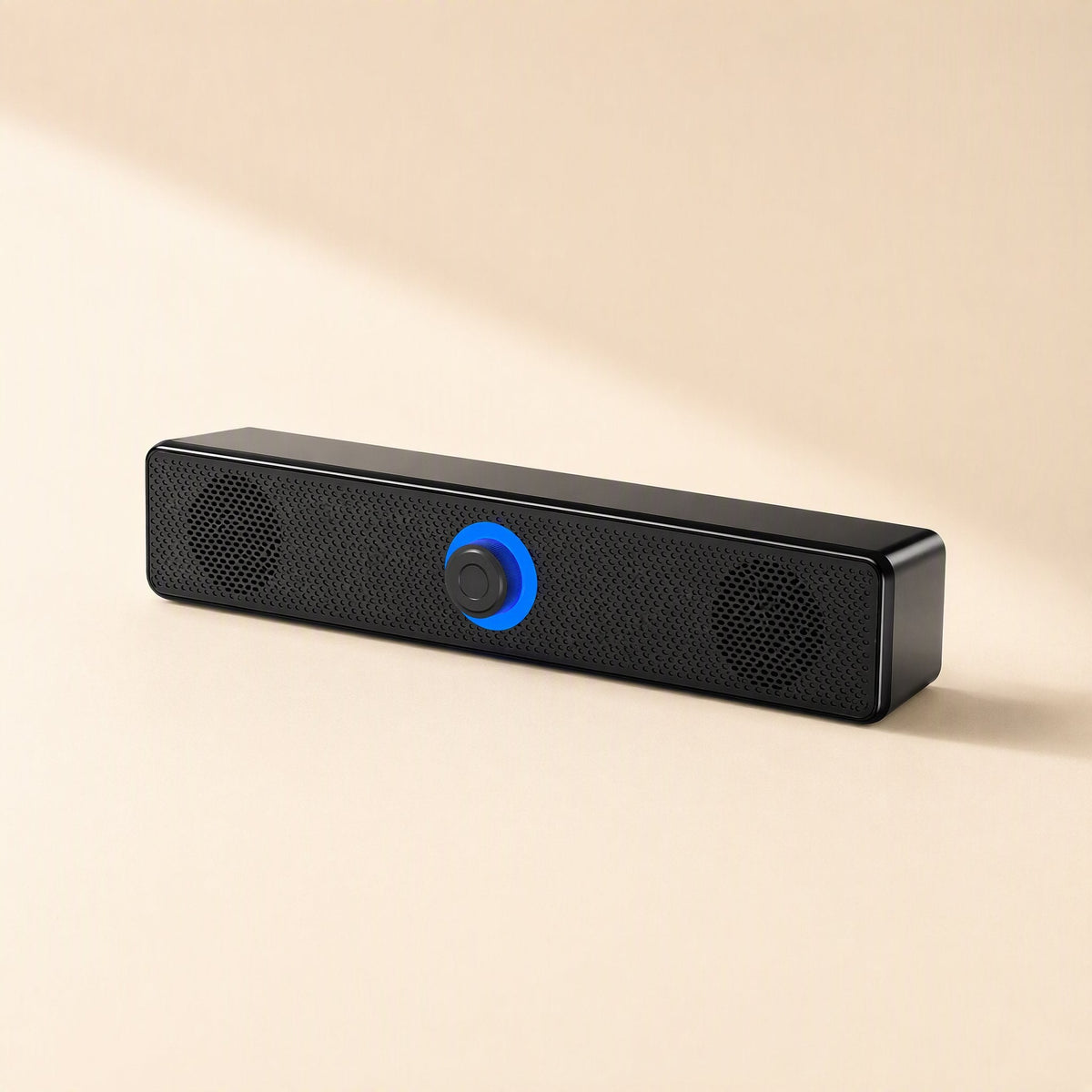 Wiretune – Front view of the black soundbar speaker with mesh grille, two round driver covers and blue knob ring